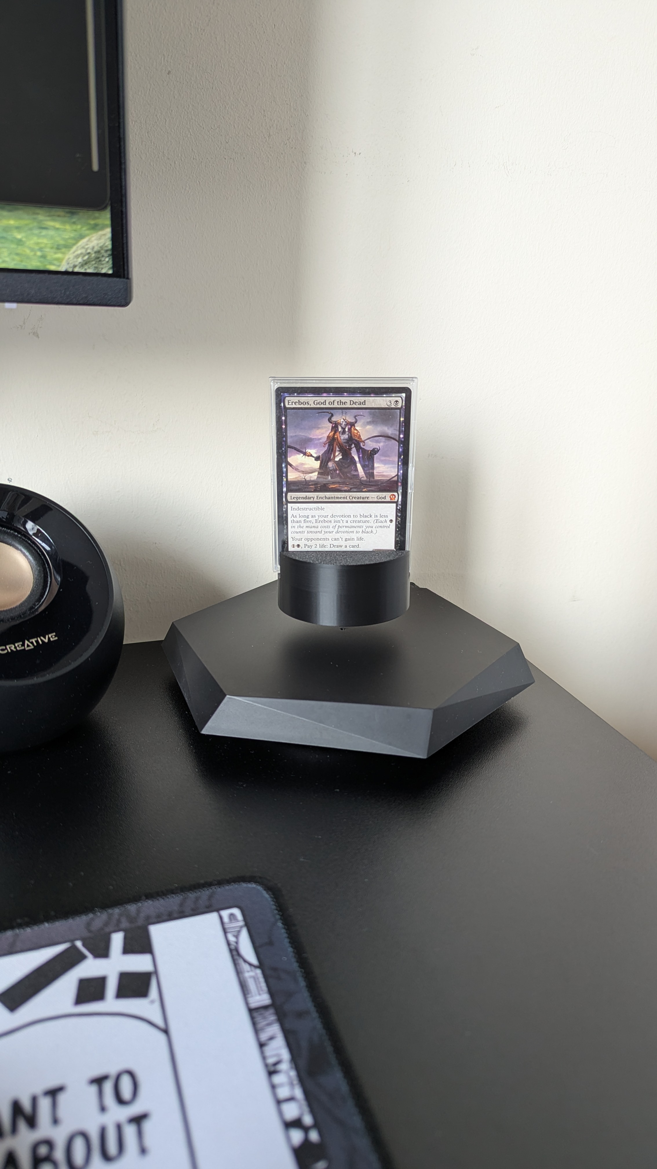 Card in a plastic slide-in case on the Polaris TCG stand